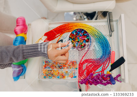 braided afro braids dreadlocks kanekalon pigtails hair with jewelry bijouterie decoration top view hand braided afro braids dreadlocks kanekalon pigtails hair with jewelry bijouterie decoration top view hand 133369233