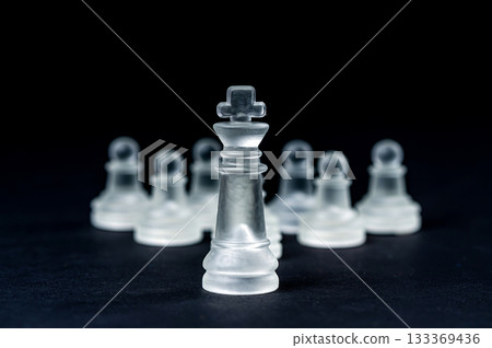 transparent glass chess on black background, selective focus on king piece, close up transparent glass chess on black background, selective focus on king piece, close up 133369436