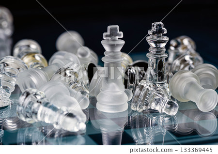 glass chess board game in black background ,selective focus on King, leadership concept 133369445
