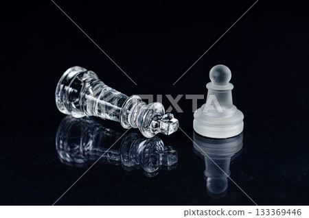 transparent glass chess on black background, selective focus on king piece, close up 133369446