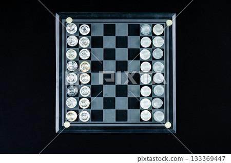 Set of transparent glass chess pieces over black, selective focus, copy space,  view from above 133369447