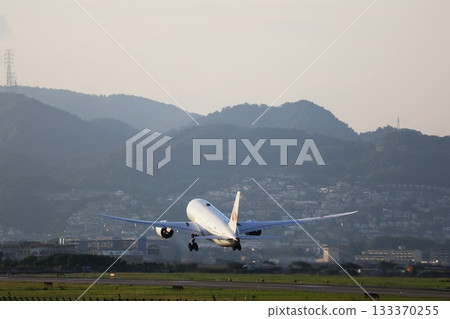 An airplane taking off in the morning sun An airplane taking off in the morning sun 133370255