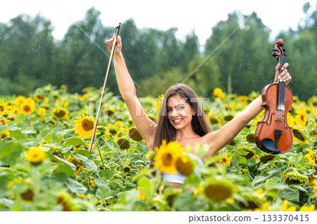 beautiful slim teenager woman with violin in yellow blooming sunflower field in rainy day beautiful slim teenager woman with violin in yellow blooming sunflower field in rainy day 133370415
