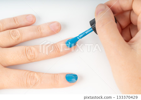 Applying nail polish in close-up. Getting manicures on your own at home 133370429