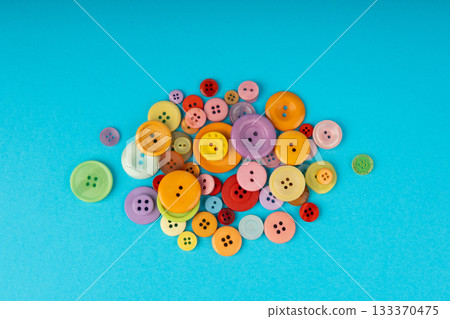 Multicolored sewing buttons. Plastic sew buttons of different colors and sizes 133370475