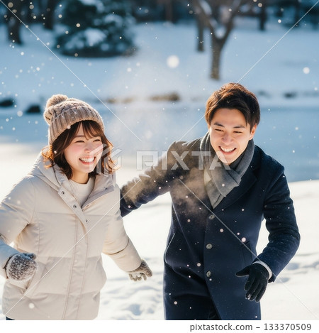 A young, friendly Japanese couple playing in a snowy place 133370509