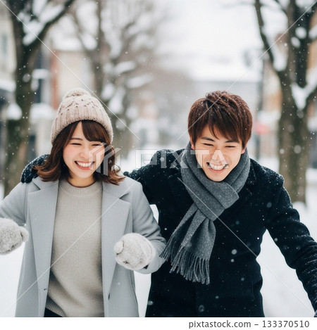 A young, friendly Japanese couple playing in a snowy place 133370510
