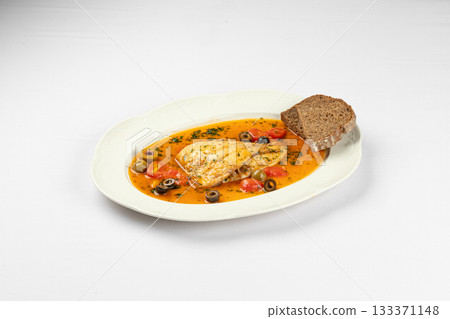 Warm fish fillet in vegetable broth with bread 133371148