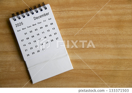 Top view of December 2025 calendar on wooden table. Year end concept. 133371503