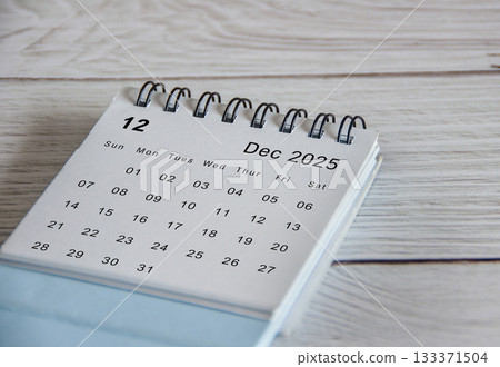 White calendar of December 2025 calendar on wooden table. Year end concept. 133371504