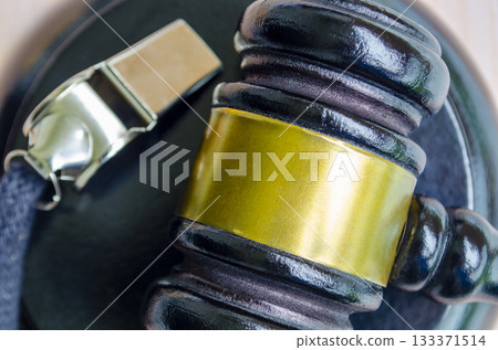 Top view of lawyer gavel with whistle next to it. 133371514