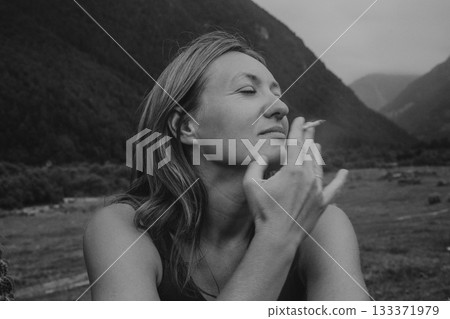 calm caucasian woman meditating quietly in grayscale, tranquil monochrome image of woman deep in 133371979
