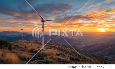 Sunset over wind turbines in a scenic mountain landscape with golden light 133372092