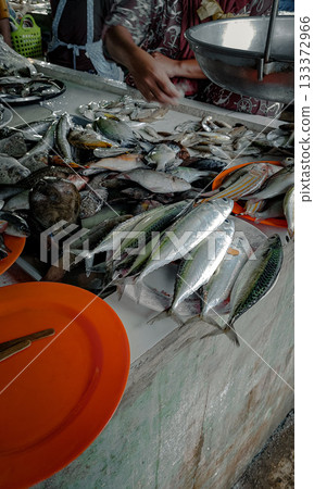 A colorful variety of fresh fish displayed on a market stall, depicting a candid daily life at the seafood market. Dipolog, Philippines A colorful variety of fresh fish displayed on a market stall, depicting a candid daily life at the seafood market. Dipolog, Philippines 133372966