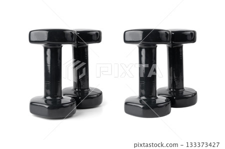 Two black dumbbells isolated. Rubberized heavy dumbbells for fitness, sport, weight exercises 133373427