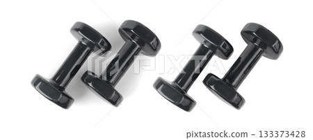 Two black dumbbells isolated. Rubberized heavy dumbbells for fitness, sport, weight exercises 133373428