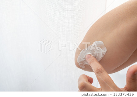 Cream on elbow skin. Applying the lotion to dry rough hands skin, elbow moisturizing creme Cream on elbow skin. Applying the lotion to dry rough hands skin, elbow moisturizing creme 133373439