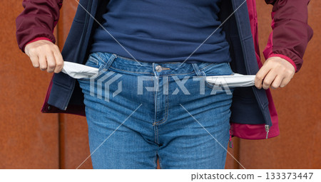 Empty pockets close-up. Woman is showing financial loss, no money, poor person Empty pockets close-up. Woman is showing financial loss, no money, poor person 133373447