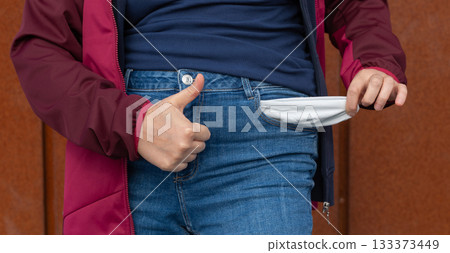 Empty pockets close-up. Woman is showing financial loss, no money, poor person Empty pockets close-up. Woman is showing financial loss, no money, poor person 133373449