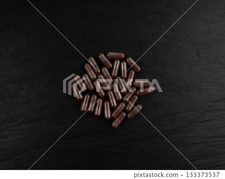 Iron capsule, Fe pills, dark red hemoglobin supplement tablets, vitamin capsules, mineral 133373537