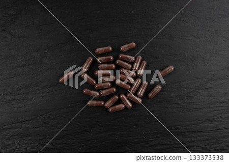 Iron capsule, Fe pills, dark red hemoglobin supplement tablets, vitamin capsules, mineral 133373538