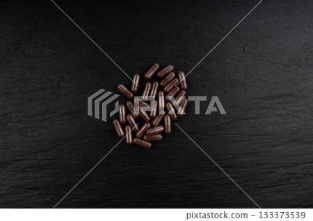 Iron capsule, Fe pills, dark red hemoglobin supplement tablets, vitamin capsules, mineral 133373539