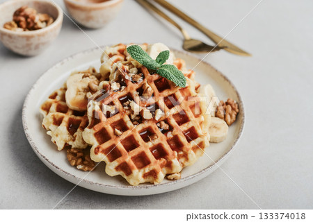 Homemade waffles with topping of honey, walnut and banana 133374018