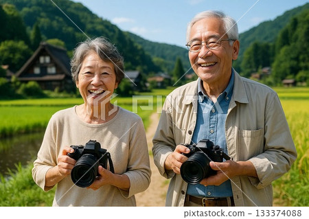 Senior couple enjoying taking photos with a single-lens reflex camera Senior couple enjoying taking photos with a single-lens reflex camera 133374088