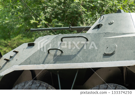 Fragment of BRDM-2 armored vehicle showing handles, hatches, and mounted machine gun in a close-up view 133374250