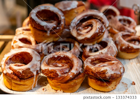A bakery lined with iced cinnamon rolls A bakery lined with iced cinnamon rolls 133374333