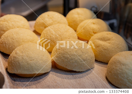 A bakery with rows of freshly baked melon bread 133374408