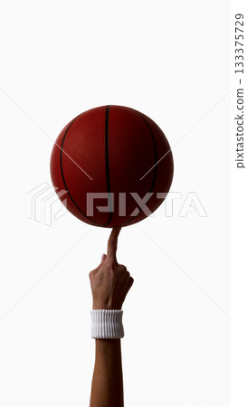 Female athlete spinning basketball on fingertip isolated on white background Female athlete spinning basketball on fingertip isolated on white background 133375729