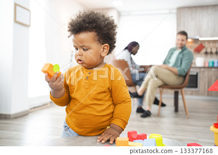 Multiracial family enjoys playtime at home on a sunny day 133377168