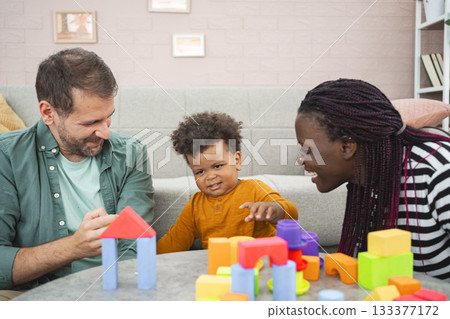 Multiracial family enjoys colorful blocks at home Multiracial family enjoys colorful blocks at home 133377172