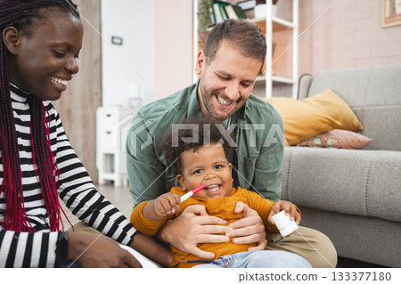 Multiracial family enjoying a playful moment at home in the afternoon 133377180
