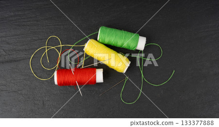 Needle and thread. Needlework object, color cotton thread spool and needle Needle and thread. Needlework object, color cotton thread spool and needle 133377888