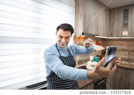 Man Taking Selfie in Kitchen Man Taking Selfie in Kitchen 133377926