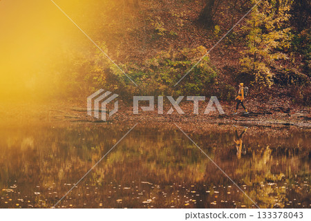 Woman Hiking Alone Autumn Forest lake 133378043