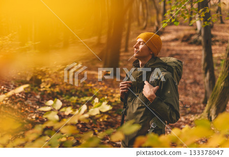 Young Man Traveler Hiking in Autumn Forest 133378047