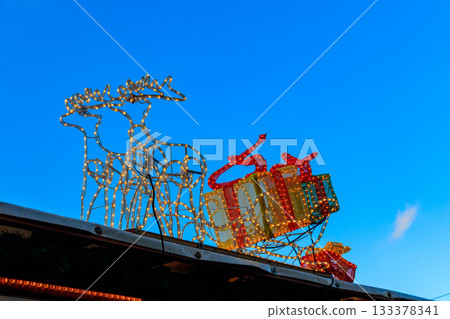 Christmas reindeers with sleigh on the roof. Christmas decoration Christmas reindeers with sleigh on the roof. Christmas decoration 133378341
