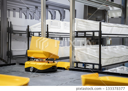Automatic warehouse robot car carries cardboard box assembly in factory. Automatic warehouse robot car carries cardboard box assembly in factory. 133378377