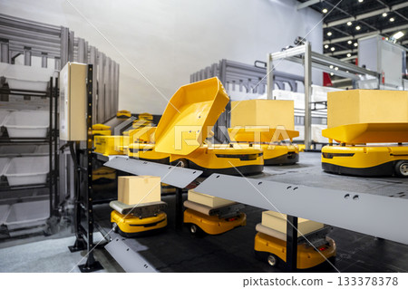 Automatic warehouse robot car carries cardboard box assembly in factory. Automatic warehouse robot car carries cardboard box assembly in factory. 133378378