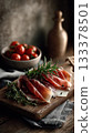 an elegant charcuterie board with slices of prosciutto or jamon, cheese, and olives on it. 133378501