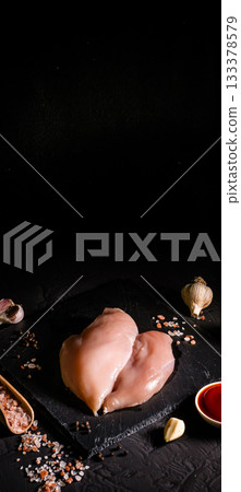 Fresh raw chicken breast fillet, organic meat. Black background. Top view Fresh raw chicken breast fillet, organic meat. Black background. Top view 133378579