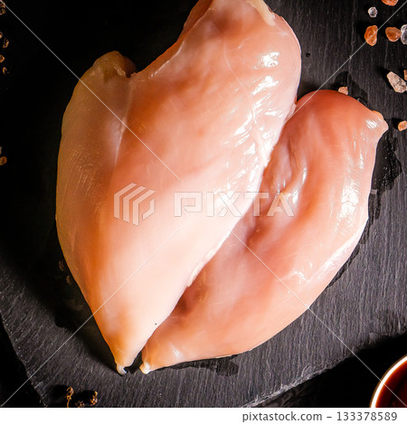 Raw organic chicken breast on a dark slate, stone, concrete or metal background.Top view with copy space. 133378589