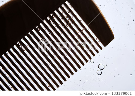 A comb with hair serum. The photo shows the texture of the cosmetic product. 133379061