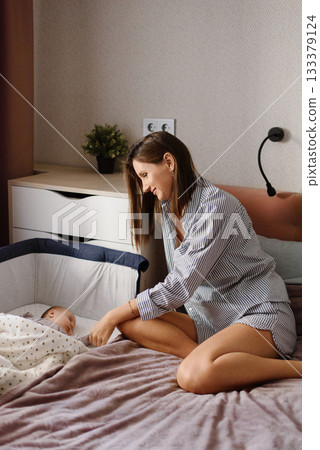 Young Mother Enjoying Peaceful Moment With Newborn Young Mother Enjoying Peaceful Moment With Newborn 133379124