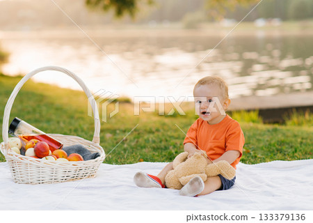 Baby Sitting With Picnic Basket 133379136