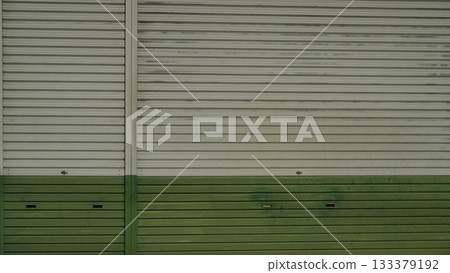 Metal shutter door painted green and white 133379192