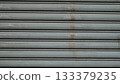 Surface of an old and worn metal shutter door 133379235